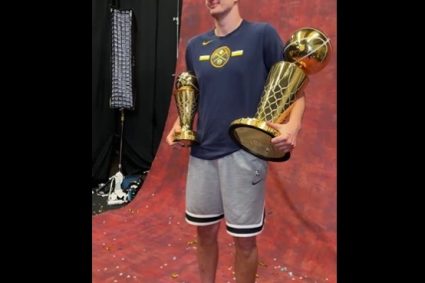 Yokedge slippers with shorts shooting makeup photo left hand championship trophy right hand FMVP Trophy